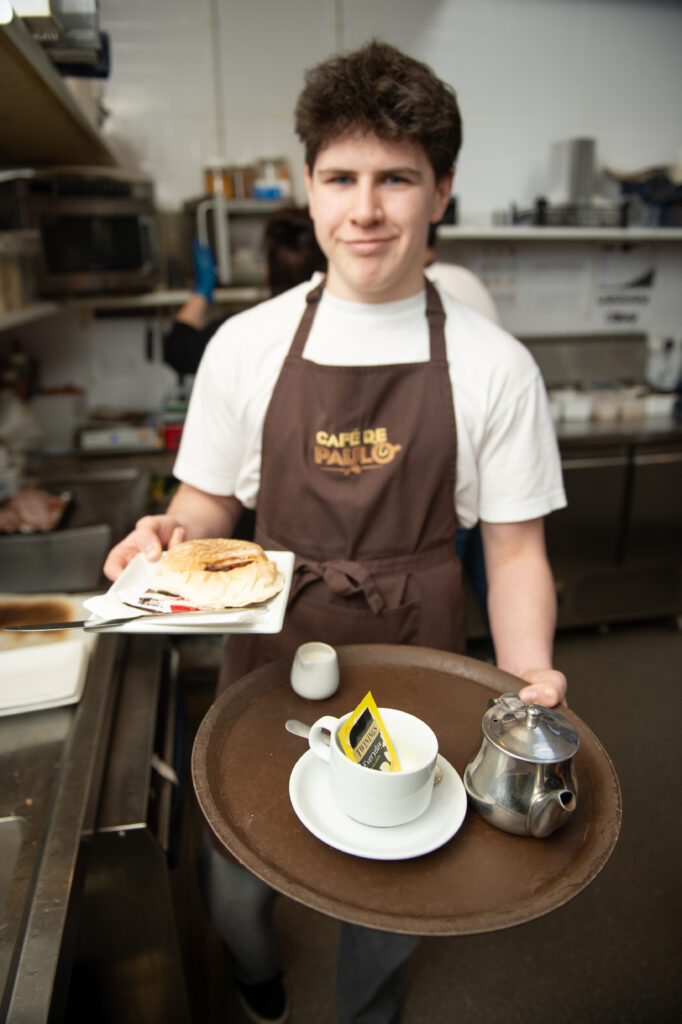 Expert barista crafting a specialty pour-over coffee at Paulo Coffee Inverness