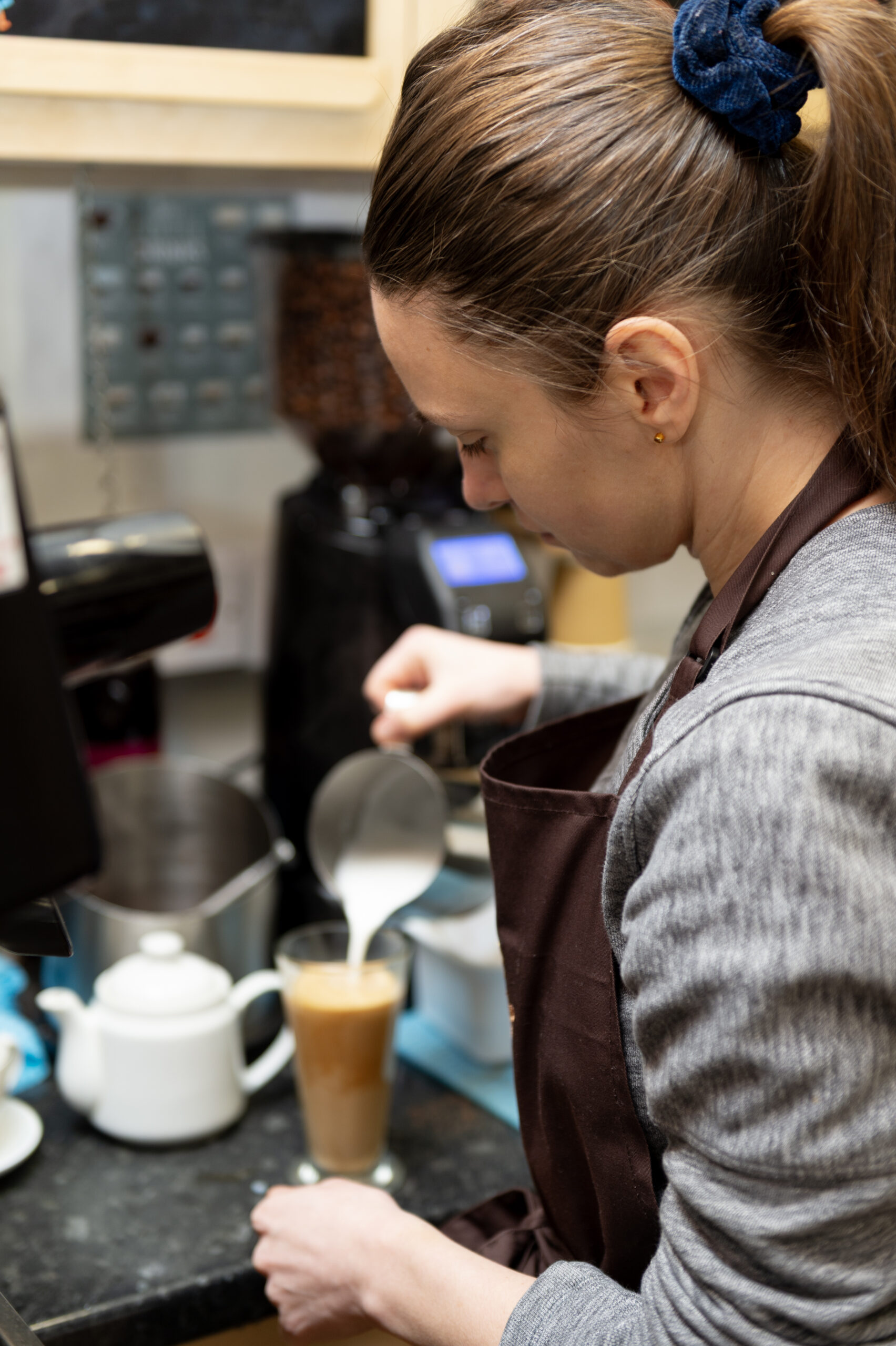 Expert barista crafting a specialty pour-over coffee at Paulo Coffee Inverness
